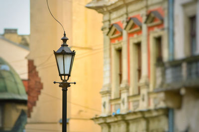 Low angle view of street light against building
