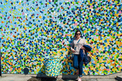 Portrait of woman standing on multi colored umbrella