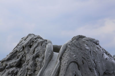 Low angle view of rock formation against sky