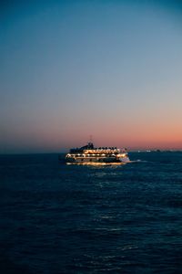 Scenic view of sea against clear sky at sunset