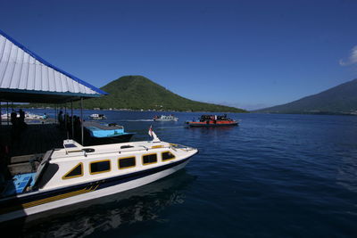 Scenic view of bay against clear blue sky