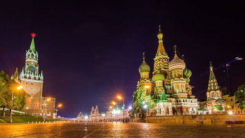 Illuminated building against sky at night