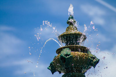 Close-up of water splashing in sea against sky