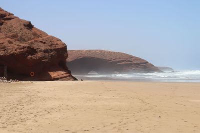 Scenic view of beach against clear sky