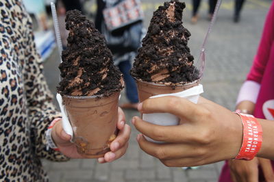 Low section of woman holding ice cream