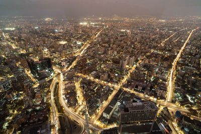 High angle view of illuminated cityscape against sky at night