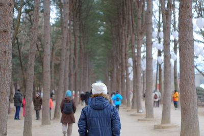 Woman walking amidst trees