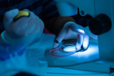 Midsection of person holding illuminated lighting equipment