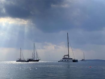 Sailboat sailing on sea against sky