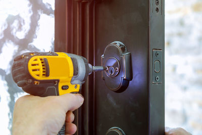 Carpenter repairing lock on door