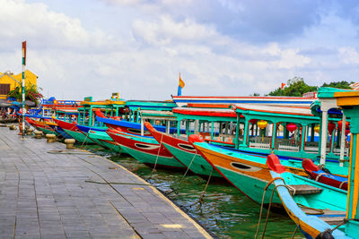 View of boats moored in sea against sky