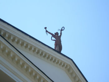 Low angle view of statue against clear blue sky