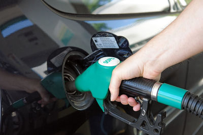 Close-up of hand filling gasoline in car