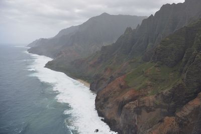 Scenic view of sea and mountains against sky