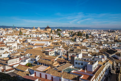 High angle view of townscape against blue sky