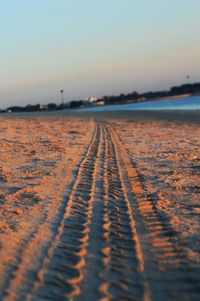 Surface level of beach against clear sky