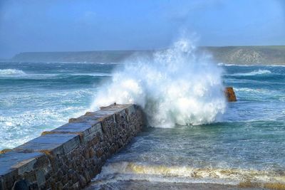 Waves breaking against sea