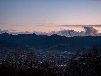 Scenic view of mountains against sky at sunset