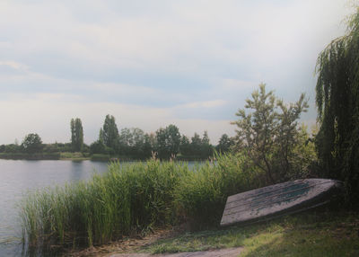 Scenic view of lake against cloudy sky