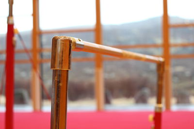 Close-up of rusty metal railing against blurred background