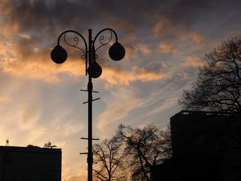 Low angle view of street light against sky at sunset
