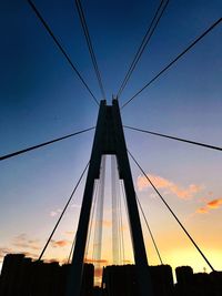 Low angle view of silhouette bridge against sky during sunset