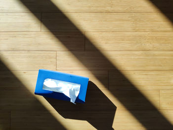 Tissue box on wooden floor and sundlight