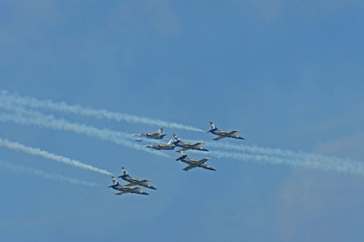 Low angle view of airshow against sky