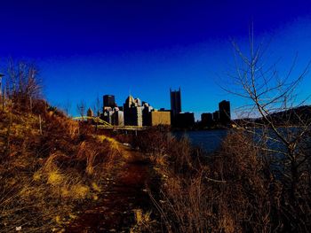 Cityscape against clear blue sky