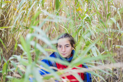 Portrait of woman sitting on field