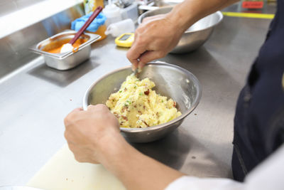 Midsection of man preparing food on table