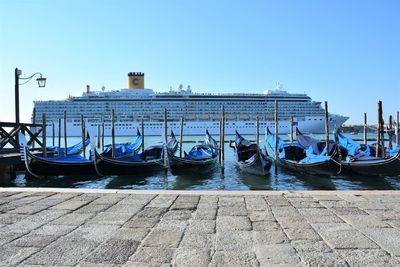 Boats in sea against clear sky