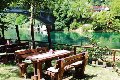 Chairs and table by river in city