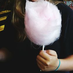 Midsection of woman holding candy floss