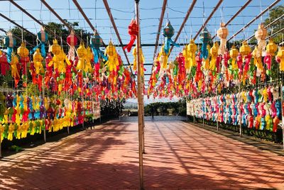 Multi colored lanterns hanging in row against sky