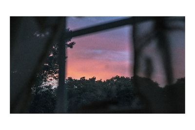 Close-up of window against sky at sunset