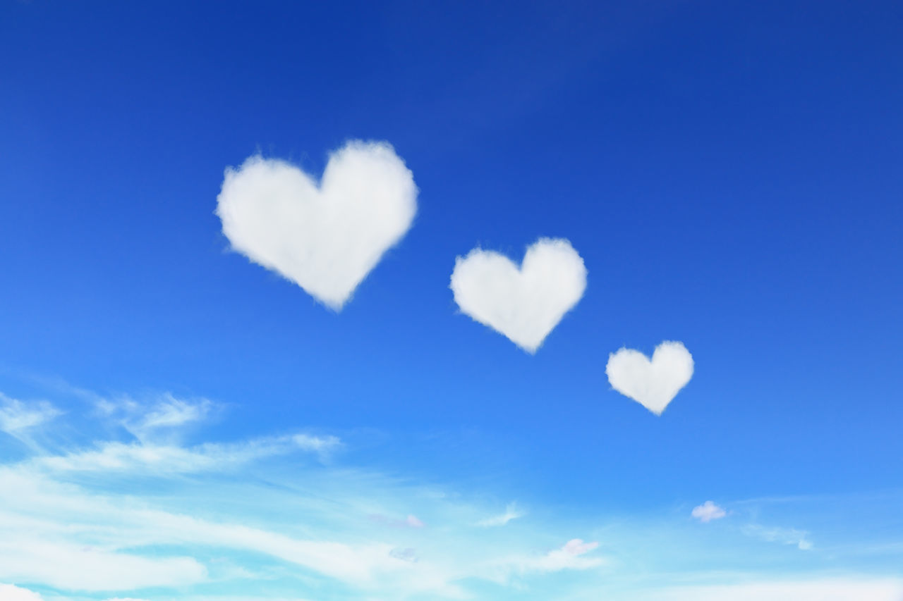 LOW ANGLE VIEW OF HEART SHAPED AGAINST BLUE SKY