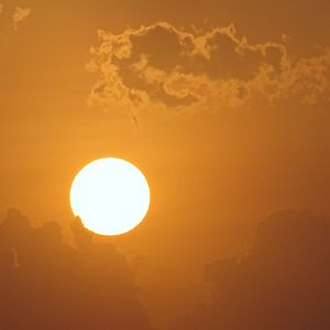 Low angle view of orange sun