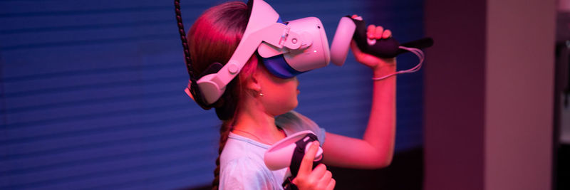 Vr game and virtual reality. kid girl gamer eight years old fun playing on simulation video game