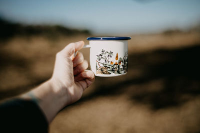 Cropped hand holding coffee