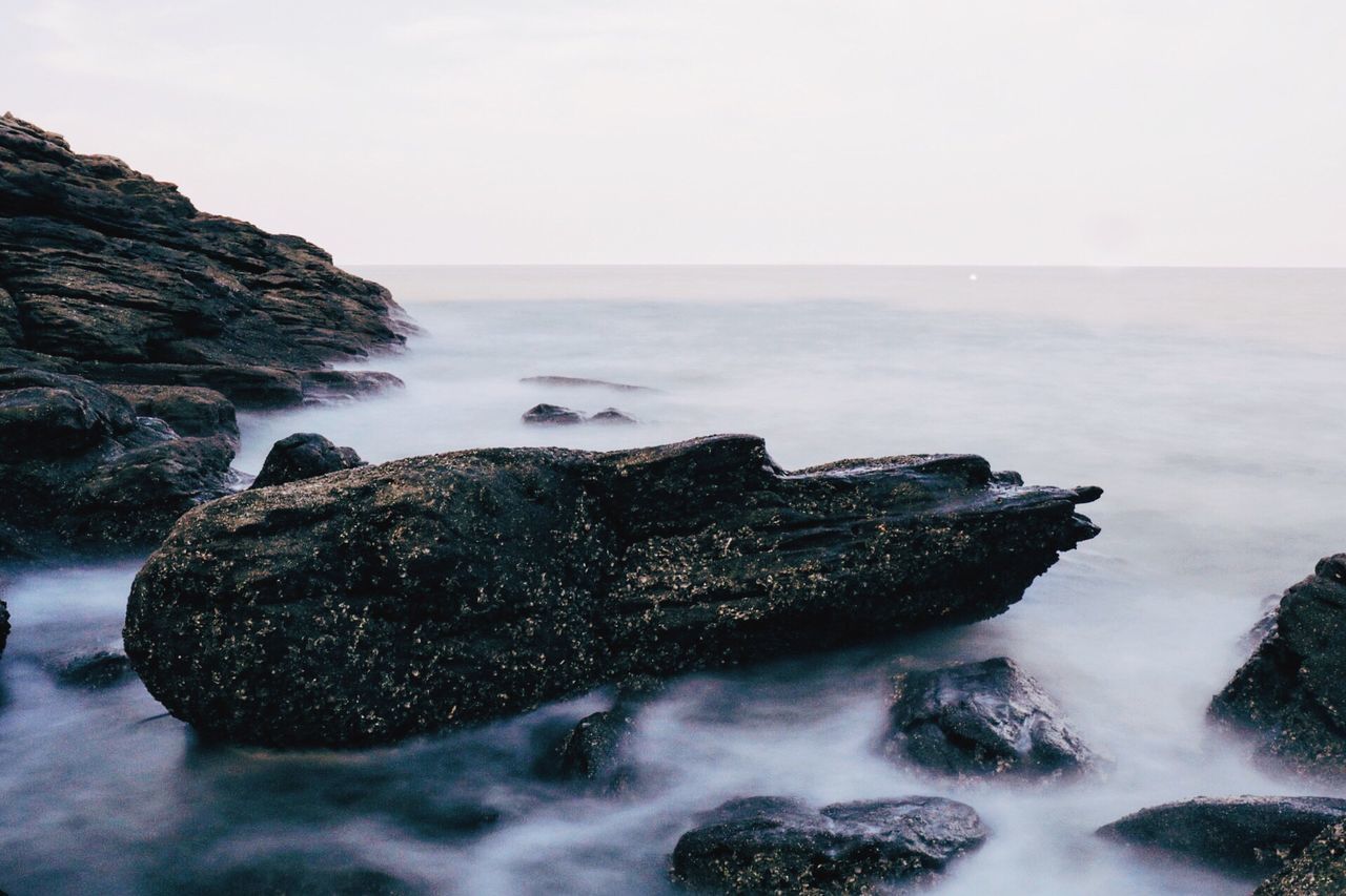 horizon over water, sea, water, scenics, tranquil scene, rock - object, tranquility, beach, beauty in nature, nature, non-urban scene, rock formation, idyllic, majestic, sky, shore, outdoors, tourism, cliff, remote, power in nature, seascape, eroded, rock, waterfront, tide, geology, vacations, no people