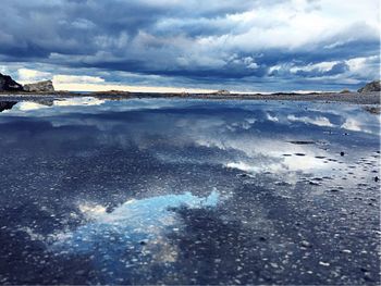 View of beach against cloudy sky