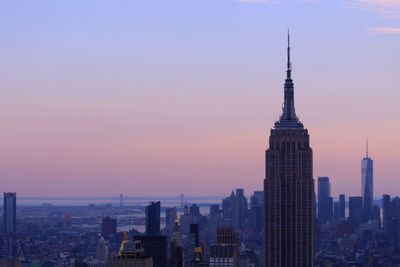 View of buildings in city at sunset