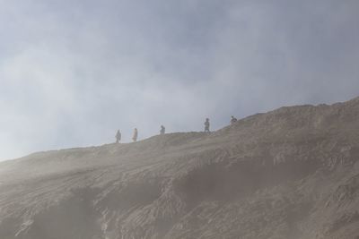 Scenic view of mountains against cloudy sky