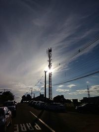 Cars on road against sky during sunset