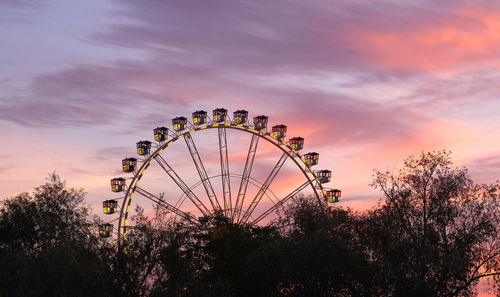 Low angle view of ferris wheel against sky