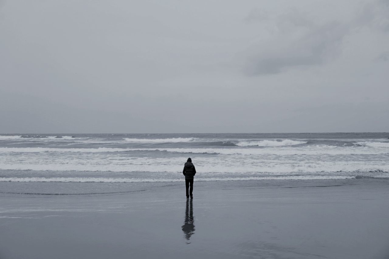 FULL LENGTH OF MAN STANDING ON BEACH