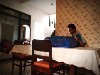 Man sitting on chair at home