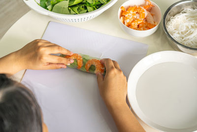 High angle view of woman preparing food on table