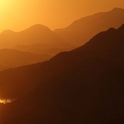 Scenic view of silhouette mountains against sky during sunset